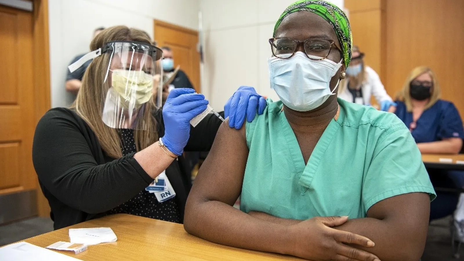 A medical practitioner administers the first vaccine at The Ohio State University 